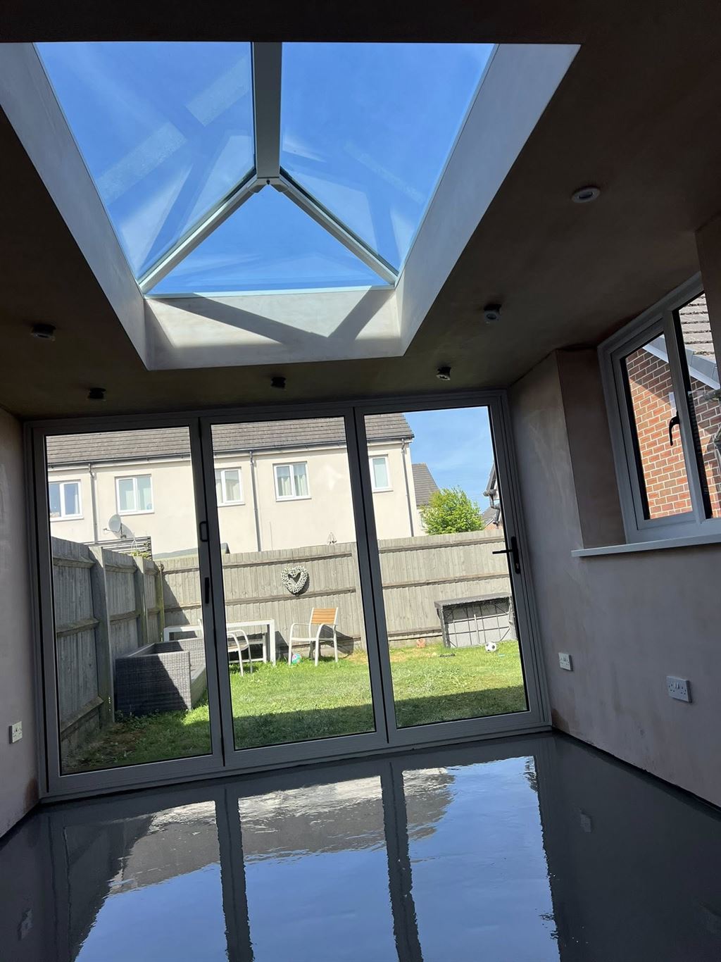 Roof lantern orangery interior with anthracite bi-fold doors