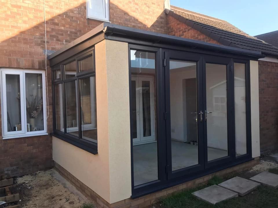 Anthracite grey orangery with bi-fold doors and side windows